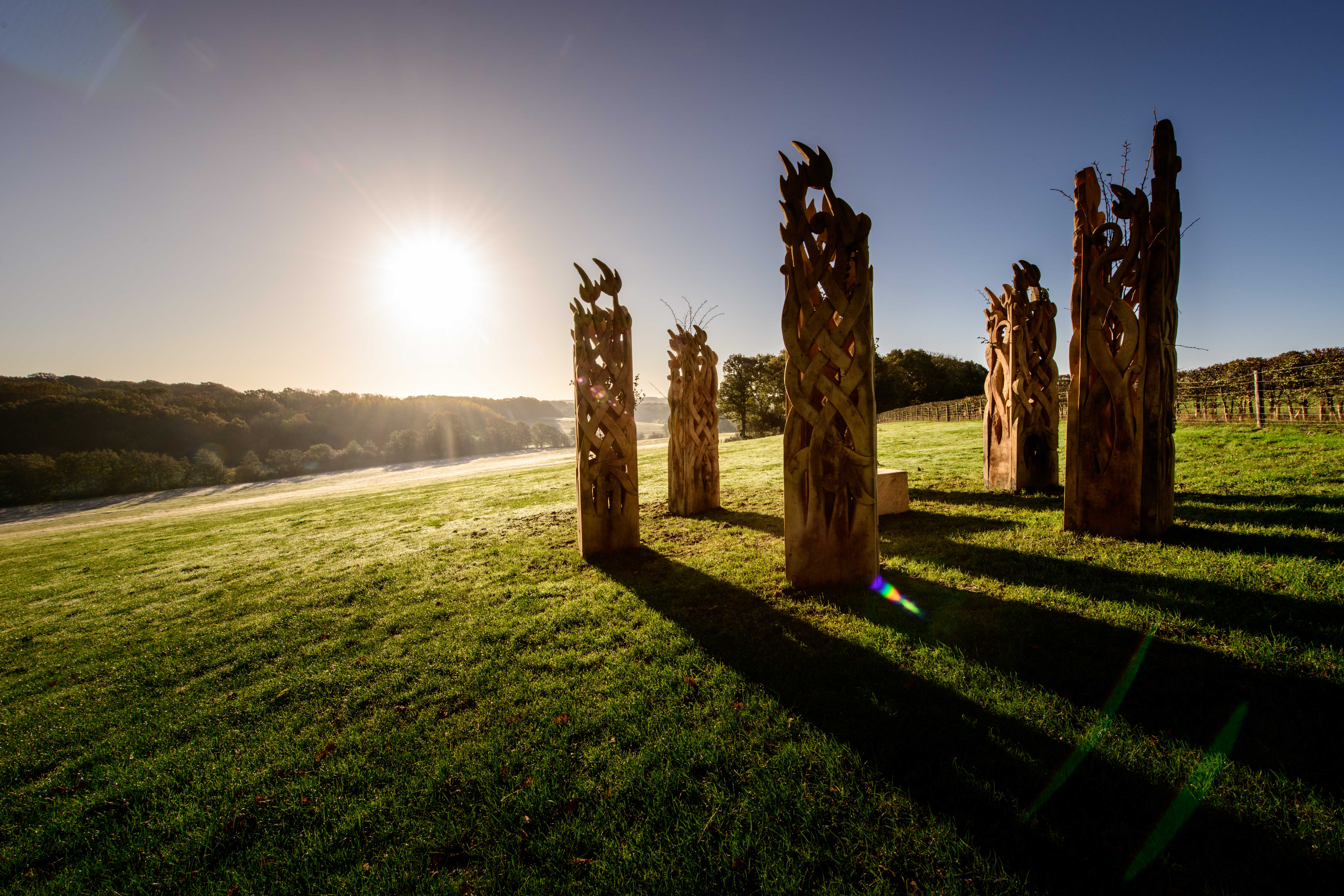 Wooden henge sculptures on the 1066 Country Walk at Westfield. Sculptures by Keith Pettit, photo by Jim Holden.